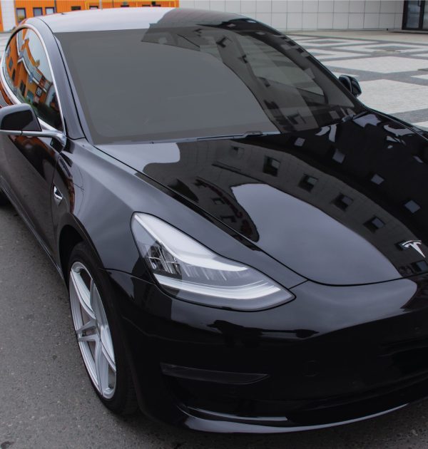 A front view of a Tesla with window film installed to the windshield